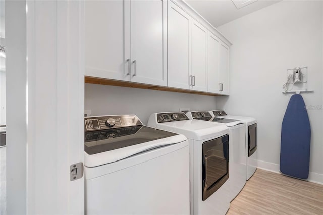 1526 Euston Dr, Reunion, FL 34747 - laundry room featuring washer and clothes dryer, cabinet space, and light wood finished floors