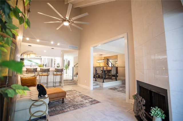 4203 Fairway Run, Tampa, FL 33618 - tiled living room with ceiling fan, high vaulted ceiling, a fireplace, and beamed ceiling