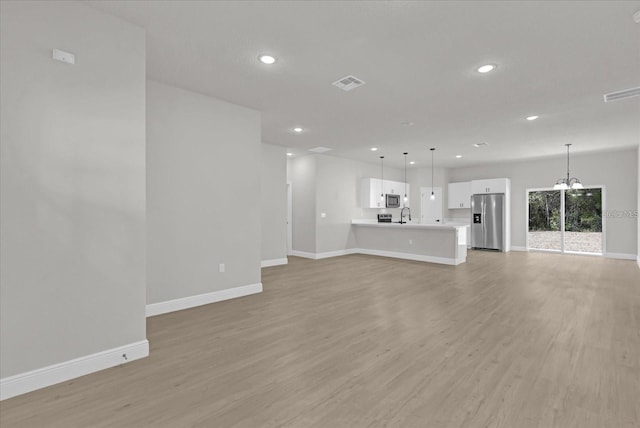 15300 SW 62nd Ct, Ocala, FL 34473 - unfurnished living room featuring recessed lighting, light wood finished floors, and a chandelier
