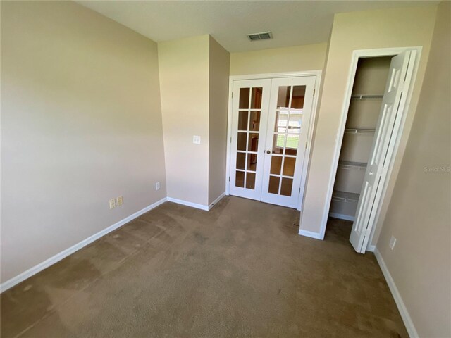 1227 Juniper Hammock St, Winter Garden, FL 34787 - unfurnished bedroom featuring french doors, dark carpet, and a closet