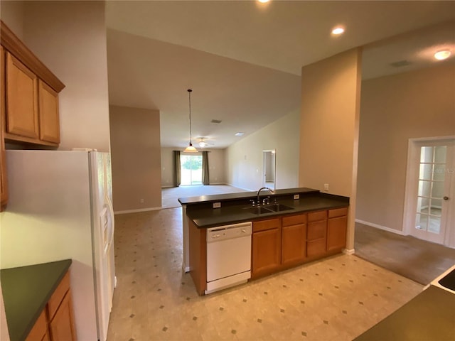 1227 Juniper Hammock St, Winter Garden, FL 34787 - kitchen featuring white appliances, dark countertops, a peninsula, brown cabinets, and open floor plan