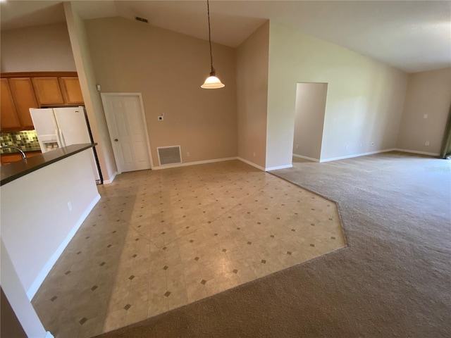 1227 Juniper Hammock St, Winter Garden, FL 34787 - unfurnished living room featuring high vaulted ceiling and light colored carpet
