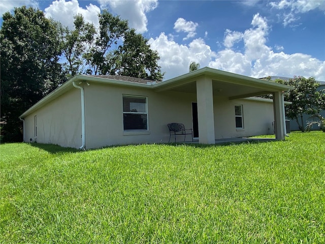 1227 Juniper Hammock St, Winter Garden, FL 34787 - rear view of property with stucco siding and a lawn