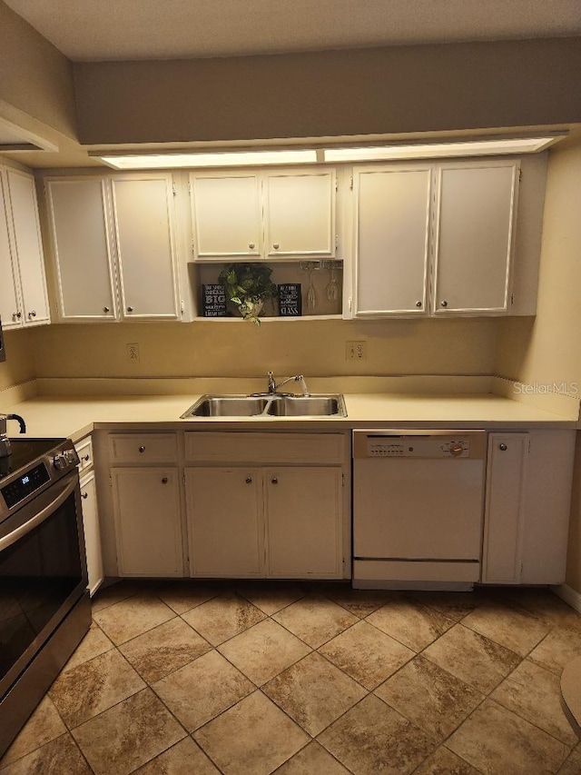 1626 Willow Run, Sebring, FL 33872 - kitchen with white dishwasher, stainless steel electric stove, light countertops, and white cabinetry