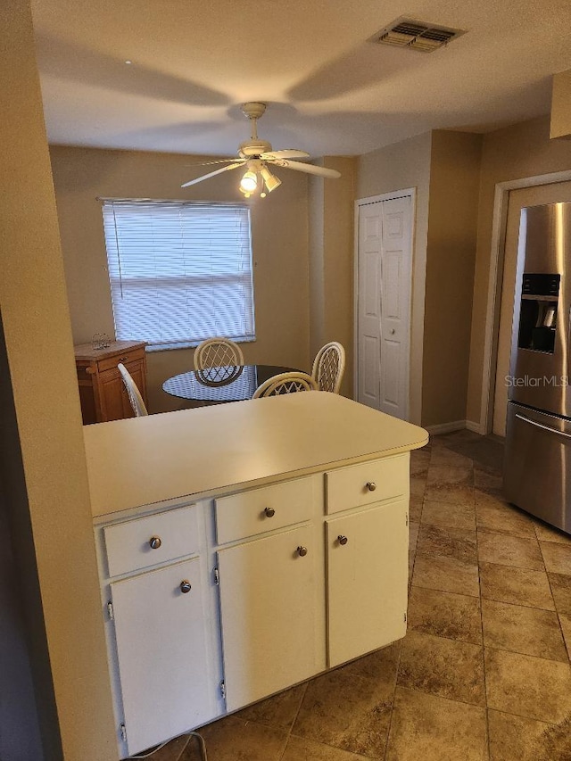 1626 Willow Run, Sebring, FL 33872 - kitchen with stainless steel refrigerator with ice dispenser, a ceiling fan, white cabinetry, and light countertops