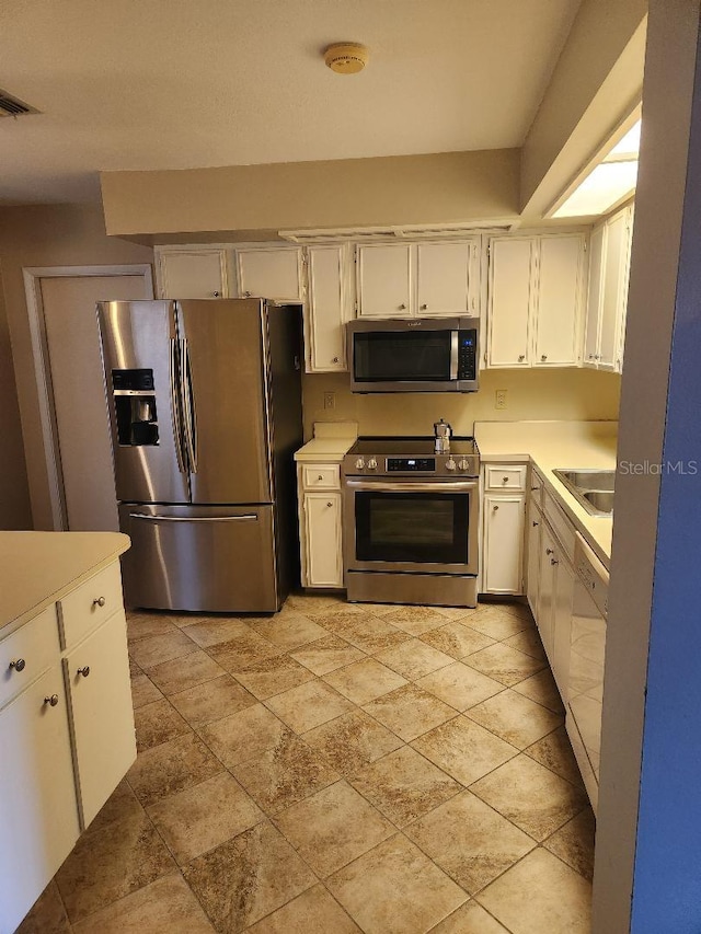 1626 Willow Run, Sebring, FL 33872 - kitchen featuring stainless steel appliances, light countertops, and white cabinets