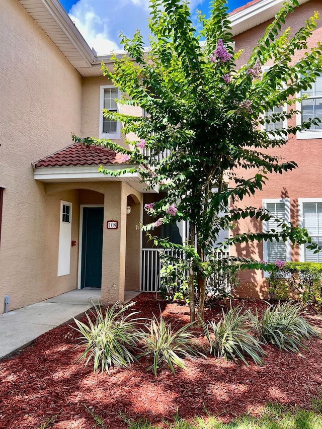 12204 Wild Iris Way Unit 108, Orlando, FL 32837 - view of front facade featuring stucco siding and a tiled roof