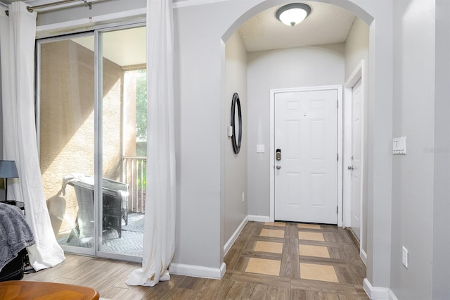 12204 Wild Iris Way Unit 108, Orlando, FL 32837 - entrance foyer with wood finished floors and arched walkways