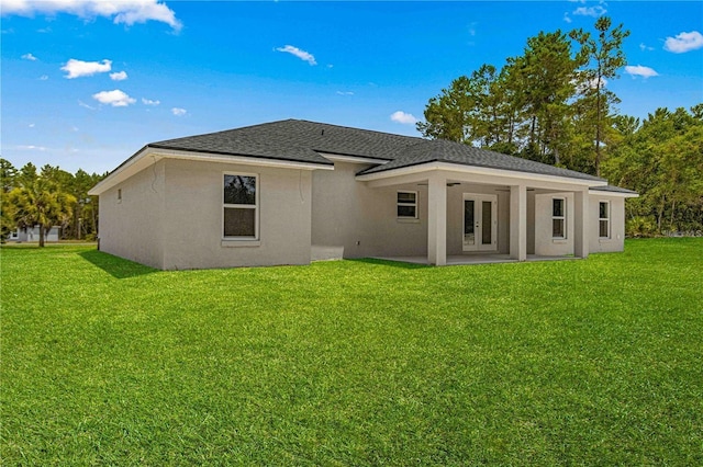 12756 SW 80th St, Dunnellon, FL 34432 - rear view of house with french doors, stucco siding, a lawn, and roof with shingles