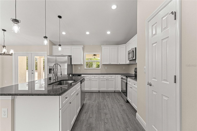 12756 SW 80th St, Dunnellon, FL 34432 - kitchen featuring appliances with stainless steel finishes, dark wood-style flooring, white cabinets, an island with sink, and recessed lighting