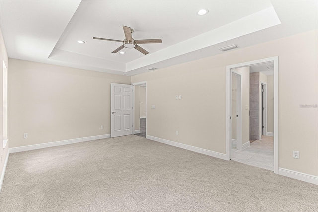 12756 SW 80th St, Dunnellon, FL 34432 - spare room featuring a tray ceiling, light carpet, ceiling fan, and recessed lighting