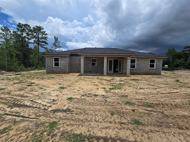 12756 SW 80th St, Dunnellon, FL 34432 - back of house featuring concrete block siding and a patio area