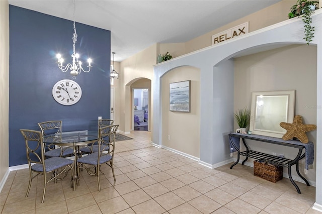 2222 Wyndham Palms Way, Kissimmee, FL 34747 - dining room with light tile patterned floors, a chandelier, and arched walkways