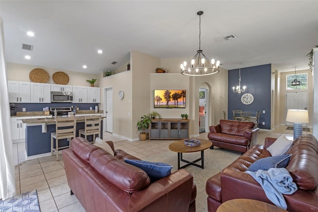 2222 Wyndham Palms Way, Kissimmee, FL 34747 - living room with a chandelier, light tile patterned flooring, arched walkways, vaulted ceiling, and recessed lighting
