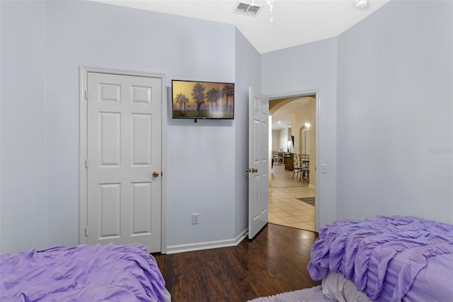 2222 Wyndham Palms Way, Kissimmee, FL 34747 - bedroom with arched walkways and wood finished floors