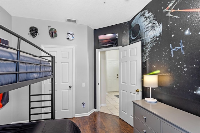 2222 Wyndham Palms Way, Kissimmee, FL 34747 - bedroom featuring wood finished floors and a textured ceiling
