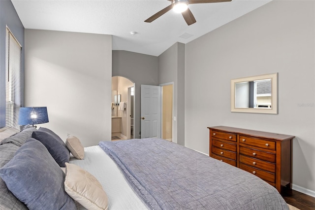 2222 Wyndham Palms Way, Kissimmee, FL 34747 - bedroom featuring arched walkways, wood finished floors, a ceiling fan, and ensuite bathroom