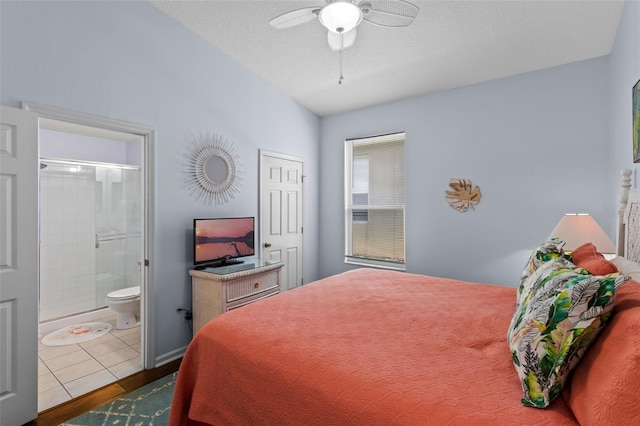 2222 Wyndham Palms Way, Kissimmee, FL 34747 - bedroom with ensuite bath, ceiling fan, lofted ceiling, and wood finished floors