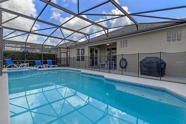 2222 Wyndham Palms Way, Kissimmee, FL 34747 - view of swimming pool with area for grilling, a patio area, a pool with connected hot tub, and glass enclosure
