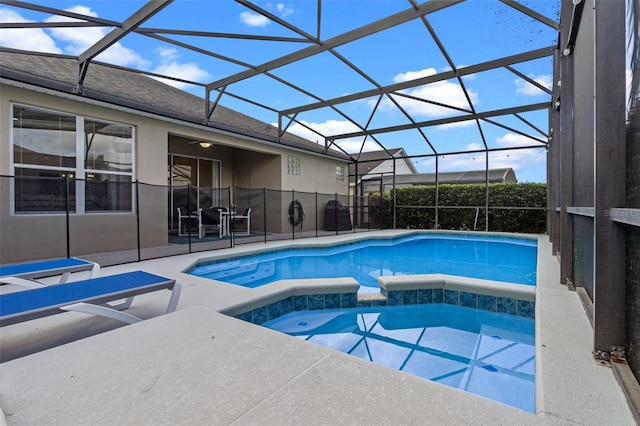 2222 Wyndham Palms Way, Kissimmee, FL 34747 - view of pool with a pool with connected hot tub, a patio area, and glass enclosure