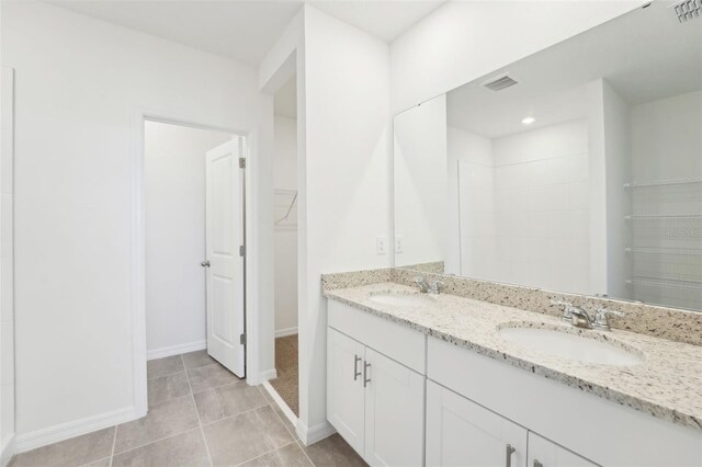 1349 Oak Valley Dr, Auburndale, FL 33823 - full bathroom with double vanity, a spacious closet, and tile patterned flooring