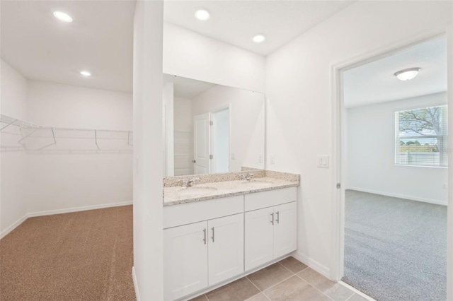 1349 Oak Valley Dr, Auburndale, FL 33823 - bathroom with double vanity, a walk in closet, and recessed lighting