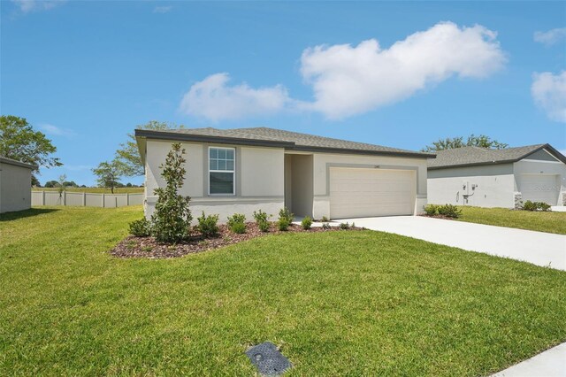1349 Oak Valley Dr, Auburndale, FL 33823 - view of front of house with a garage, stucco siding, and driveway