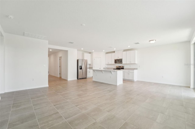 1349 Oak Valley Dr, Auburndale, FL 33823 - unfurnished living room with recessed lighting and light tile patterned floors