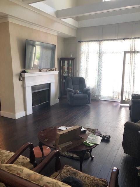 310 W Lake Ave, Auburndale, FL 33823 - living area featuring a fireplace, wood-type flooring, and plenty of natural light