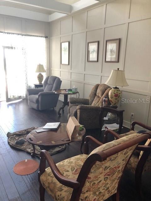 310 W Lake Ave, Auburndale, FL 33823 - living room featuring a decorative wall, hardwood / wood-style floors, and plenty of natural light