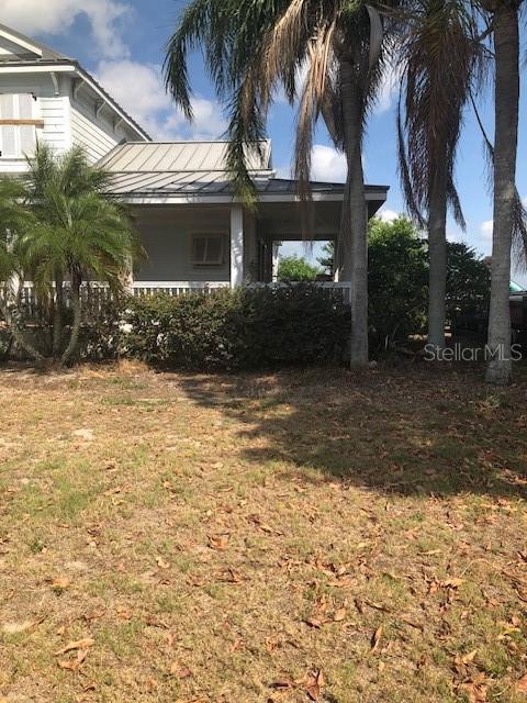 310 W Lake Ave, Auburndale, FL 33823 - view of side of property featuring a yard and a standing seam roof