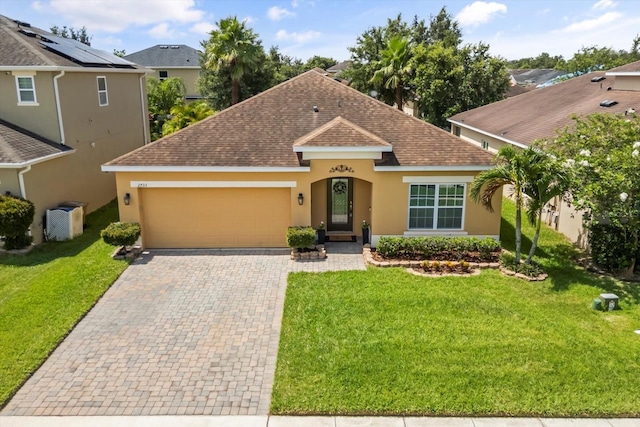 2733 Big Timber Dr, Kissimmee, FL 34758 - view of front of property with a shingled roof, stucco siding, an attached garage, a front yard, and decorative driveway
