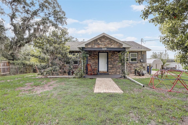 369 Bluff Lake Rd, Mascotte, FL 34753 - rear view of property featuring stone siding and a shingled roof