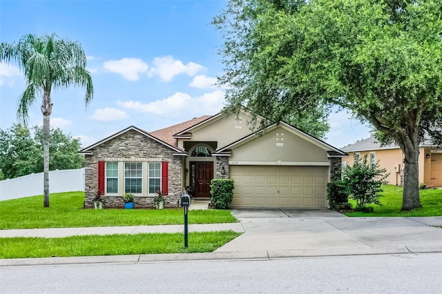 1112 Spruce Ridge Ct, Minneola, FL 34715 - single story home featuring stone siding, an attached garage, stucco siding, and driveway