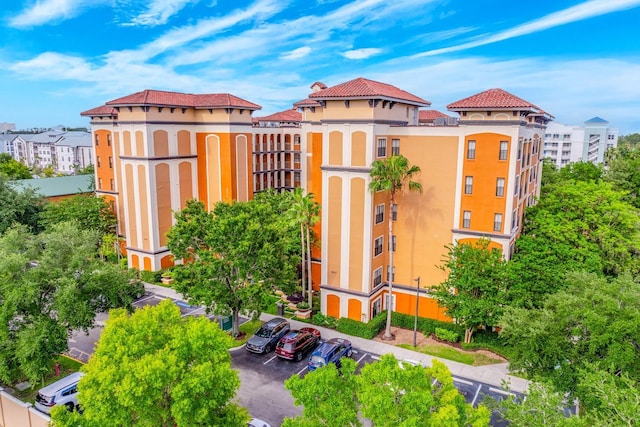 12527 Floridays Resort Dr Unit E104, Orlando, FL 32821 - view of building exterior featuring uncovered parking
