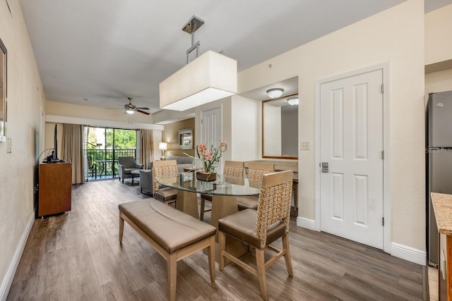 12527 Floridays Resort Dr Unit E104, Orlando, FL 32821 - dining area with wood finished floors and ceiling fan