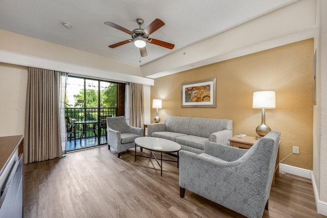 12527 Floridays Resort Dr Unit E104, Orlando, FL 32821 - living area with a ceiling fan and wood finished floors