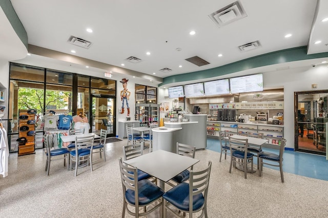 12527 Floridays Resort Dr Unit E104, Orlando, FL 32821 - dining area featuring speckled floor and recessed lighting