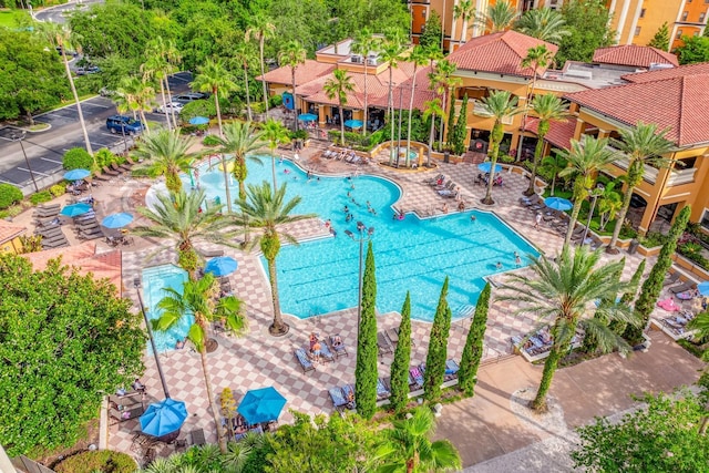 12527 Floridays Resort Dr Unit E104, Orlando, FL 32821 - community pool featuring a patio area
