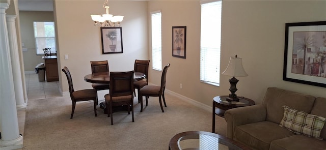 844 Suffolk Pl, Davenport, FL 33896 - dining space with a chandelier, decorative columns, and light carpet