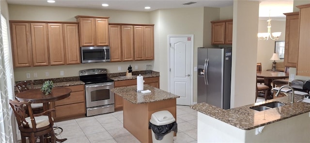 844 Suffolk Pl, Davenport, FL 33896 - kitchen featuring stainless steel appliances, dark stone countertops, a center island, a chandelier, and recessed lighting