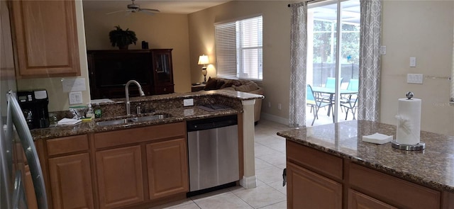 844 Suffolk Pl, Davenport, FL 33896 - kitchen with stainless steel dishwasher, dark stone countertops, a ceiling fan, light tile patterned floors, and open floor plan