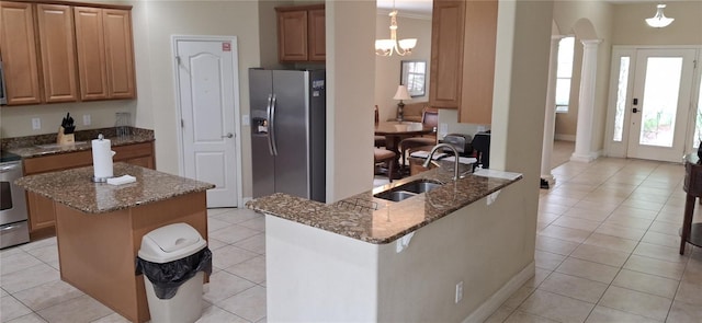844 Suffolk Pl, Davenport, FL 33896 - kitchen with appliances with stainless steel finishes, ornate columns, dark stone counters, and light tile patterned floors