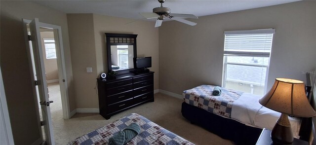 844 Suffolk Pl, Davenport, FL 33896 - bedroom with multiple windows, light colored carpet, and a ceiling fan