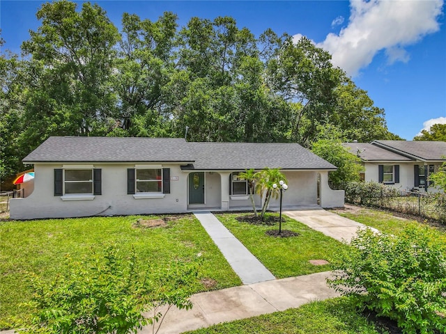 2109 Hartwell Ave, Sanford, FL 32771 - ranch-style home featuring a front lawn, stucco siding, driveway, and a shingled roof