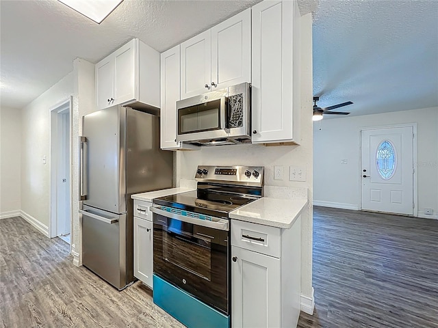 2109 Hartwell Ave, Sanford, FL 32771 - kitchen featuring stainless steel appliances, light wood-type flooring, light countertops, a ceiling fan, and a textured ceiling
