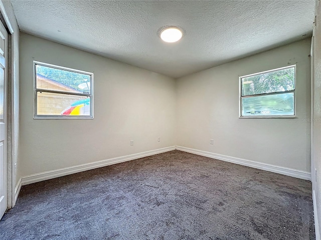 2109 Hartwell Ave, Sanford, FL 32771 - spare room with a textured ceiling and dark colored carpet