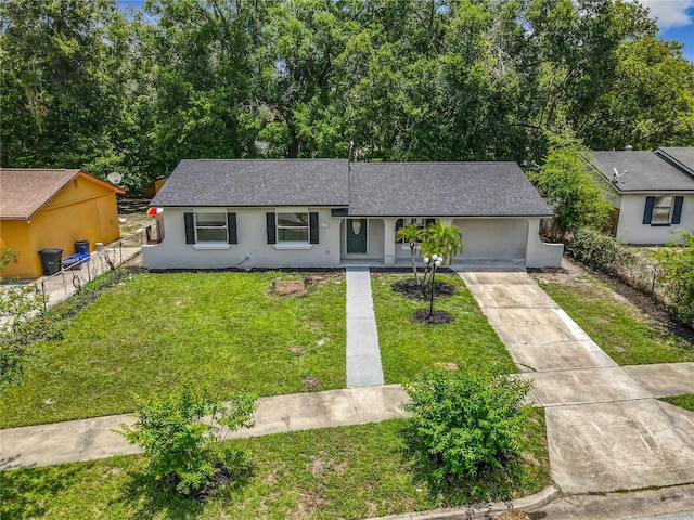 2109 Hartwell Ave, Sanford, FL 32771 - view of front of house with a shingled roof, concrete driveway, stucco siding, and a garage