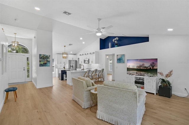 189 Blackstone Creek Rd, Groveland, FL 34736 - living area with light wood finished floors, a chandelier, ceiling fan, high vaulted ceiling, and recessed lighting