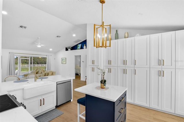 189 Blackstone Creek Rd, Groveland, FL 34736 - kitchen featuring dishwasher, vaulted ceiling, white cabinets, light wood-style flooring, and open floor plan